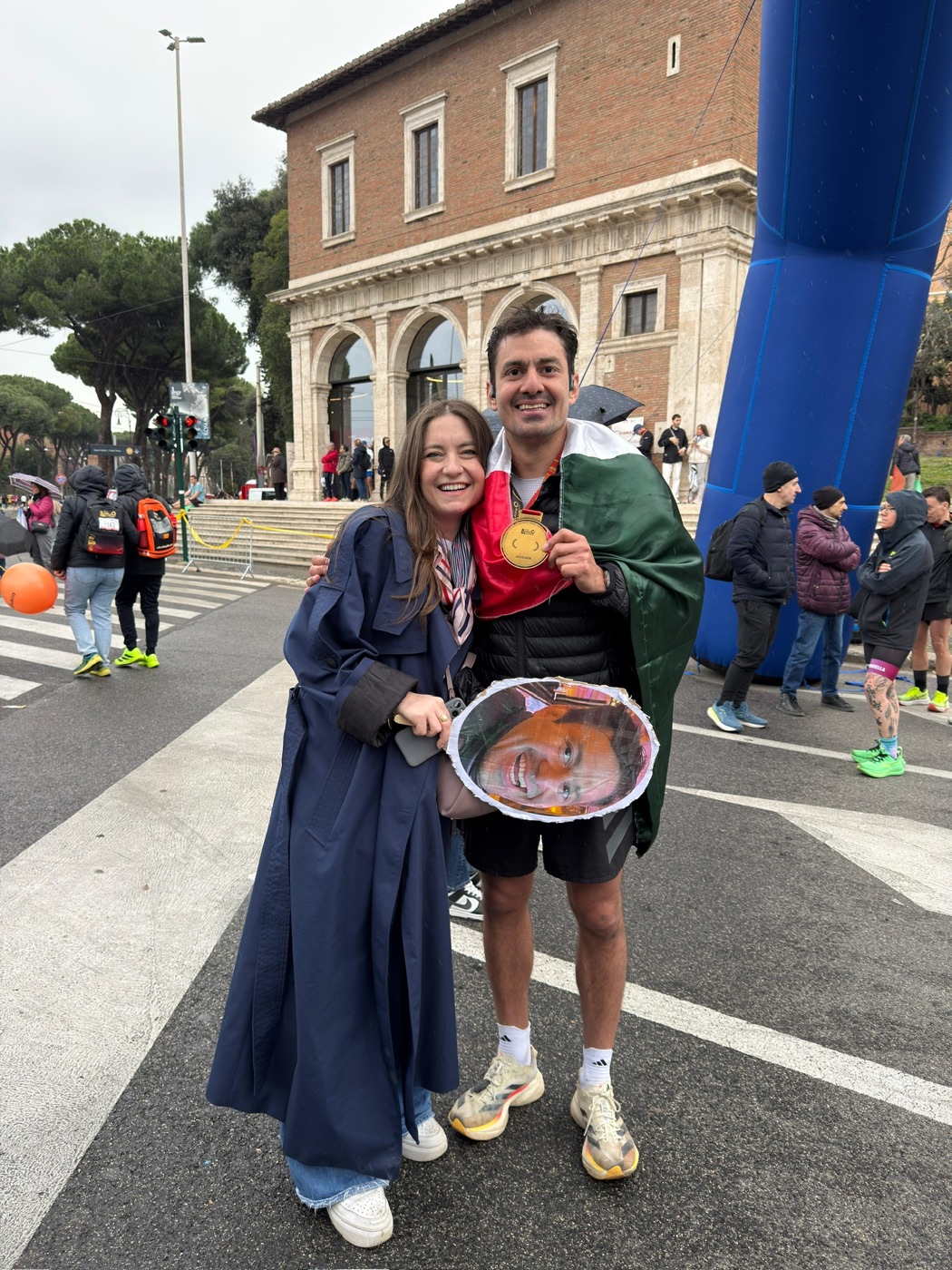 Rafa with a marathon medal and Eli cheering in Rome